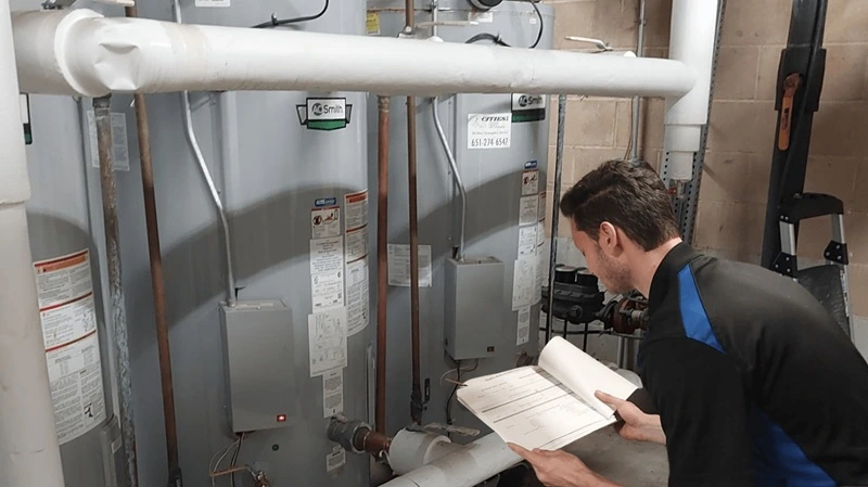BMM tech working on water heaters